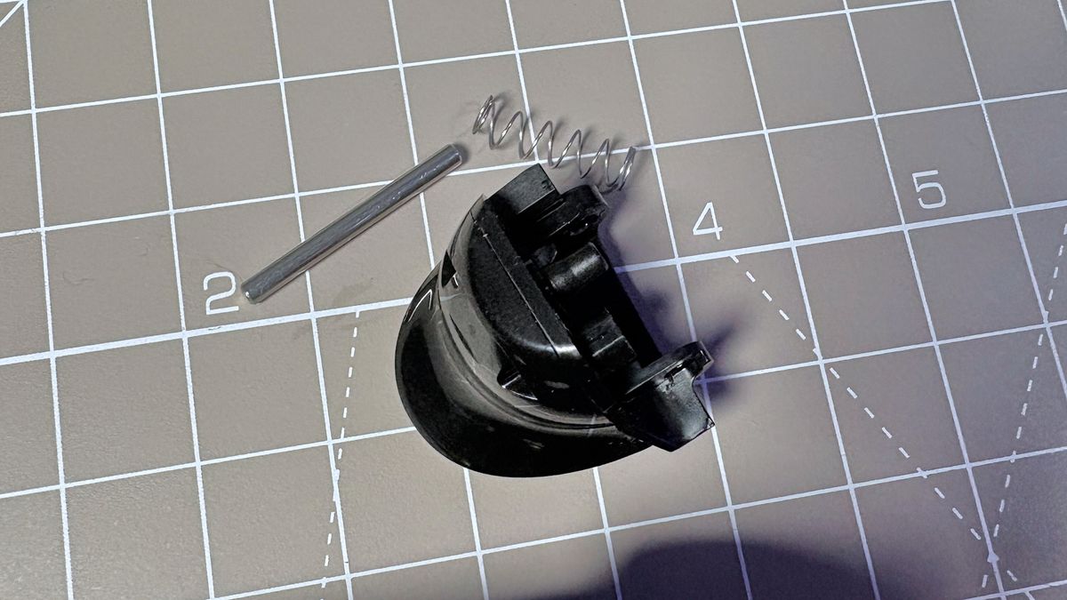 The Steam Controller on a desk during a teardown, with various parts removed.