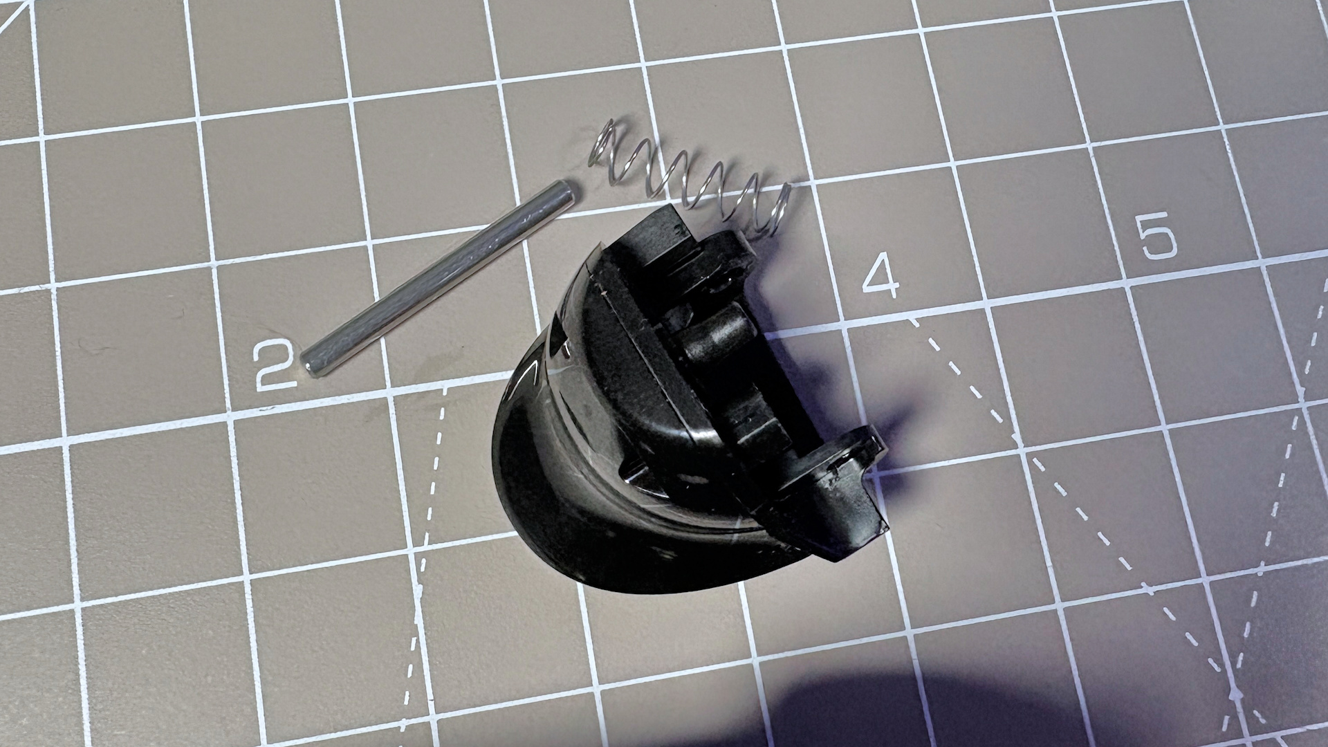 The Steam Controller on a desk during a teardown, with various parts removed.