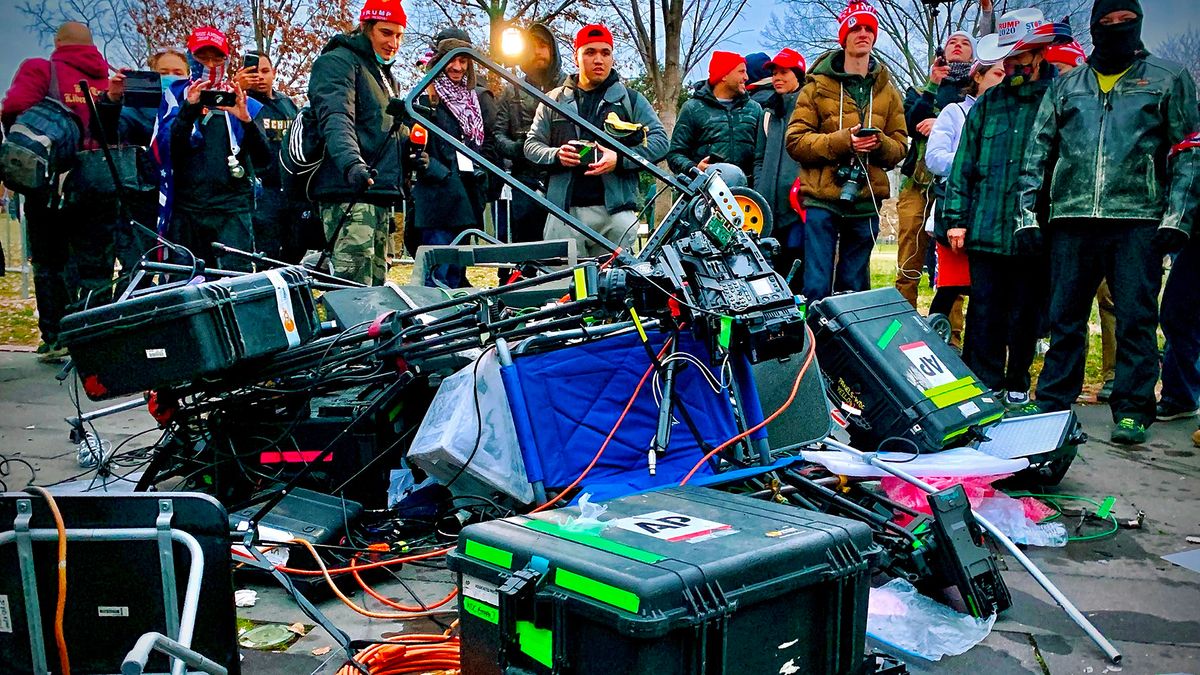 Supporters of President Donald Trump stand next to media equipment they destroyed during a protest on Jan. 6, 2021 outside the Capitol in Washington, DC.