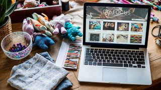 Best laptop for Cricut; a laptop surrounded by crafting products