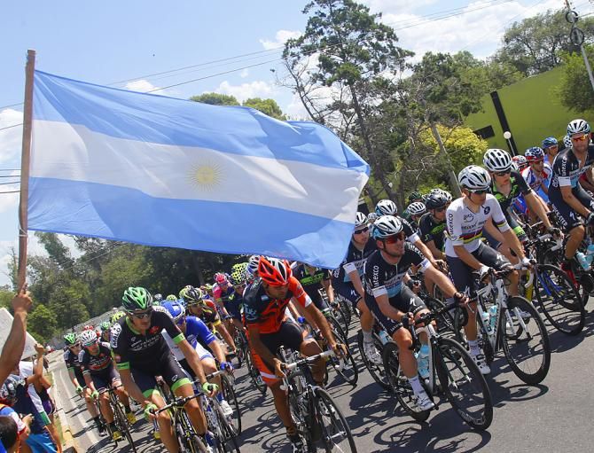 Fans wave Argentina's flag as the peloton passes