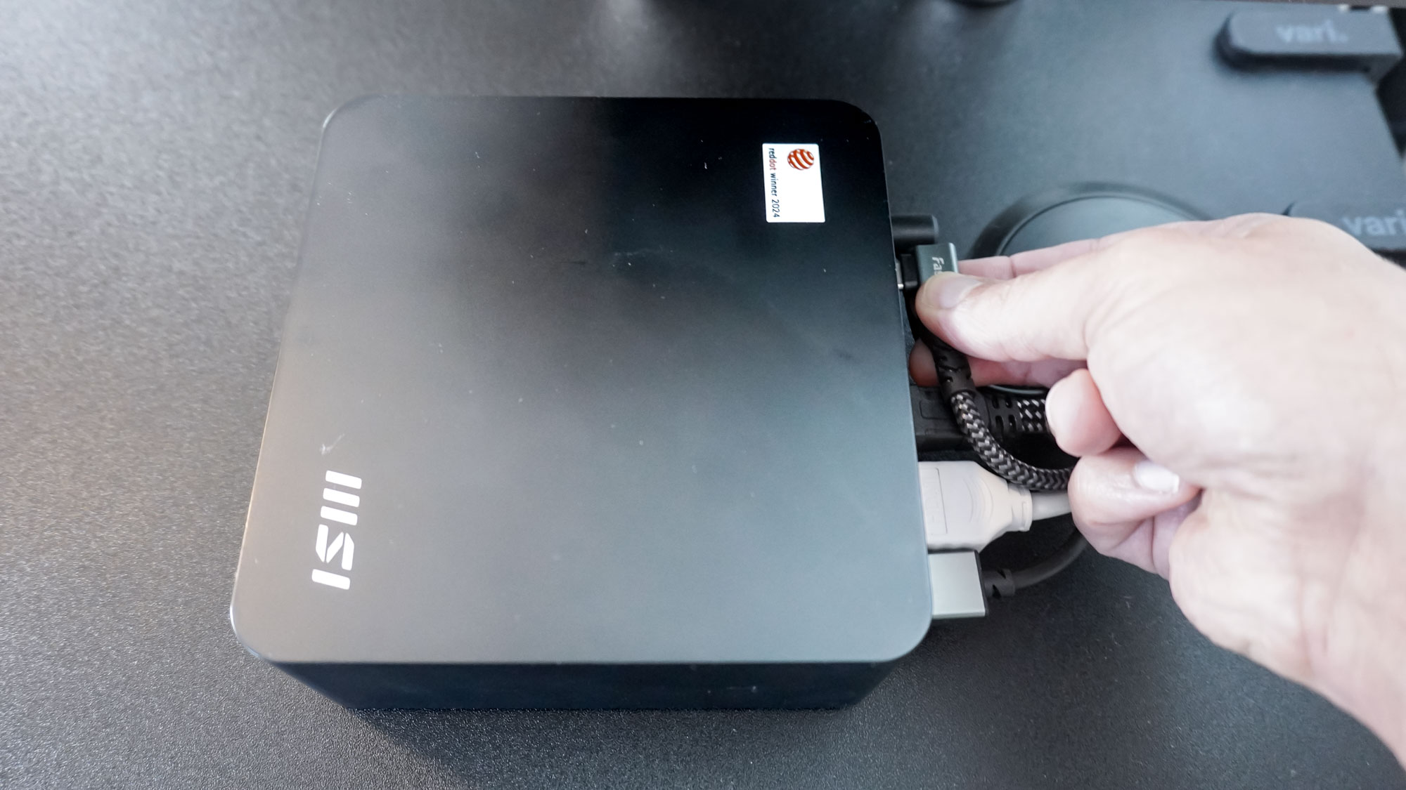 Plugging a USB-C cable into the back of the MSI Cubi NUC 1M mini PC