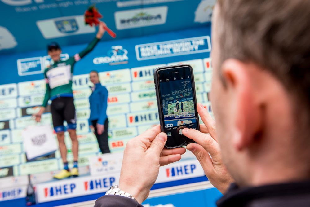 A fan gets a photo of the podium ceremony at Tour of Croatia