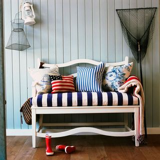 hallway with striped bench and storm lantern