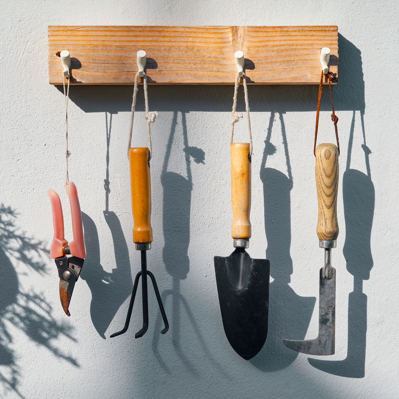 garden tools hanging on pegs