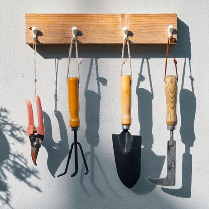 garden tools hanging on pegs