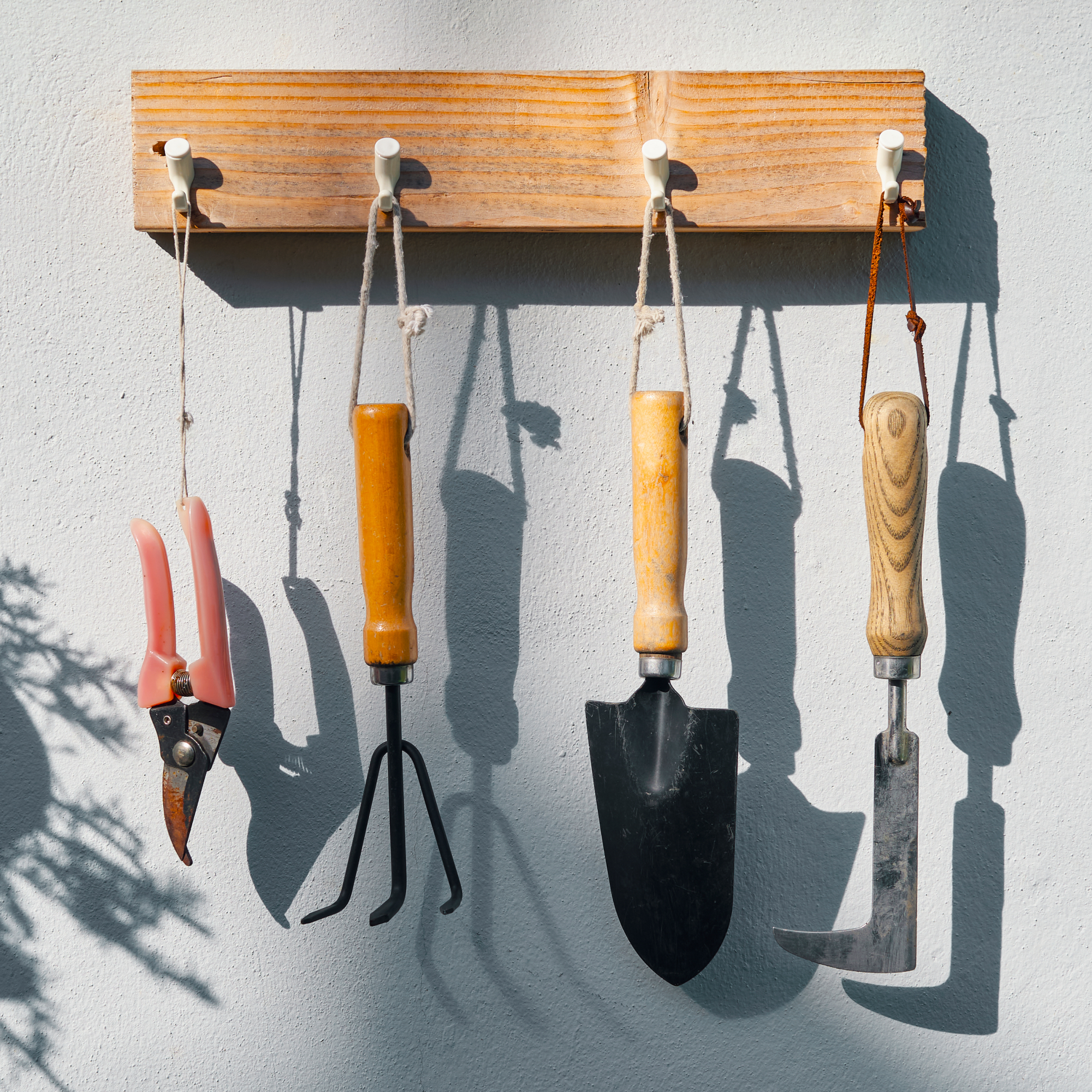 garden tools hanging on pegs