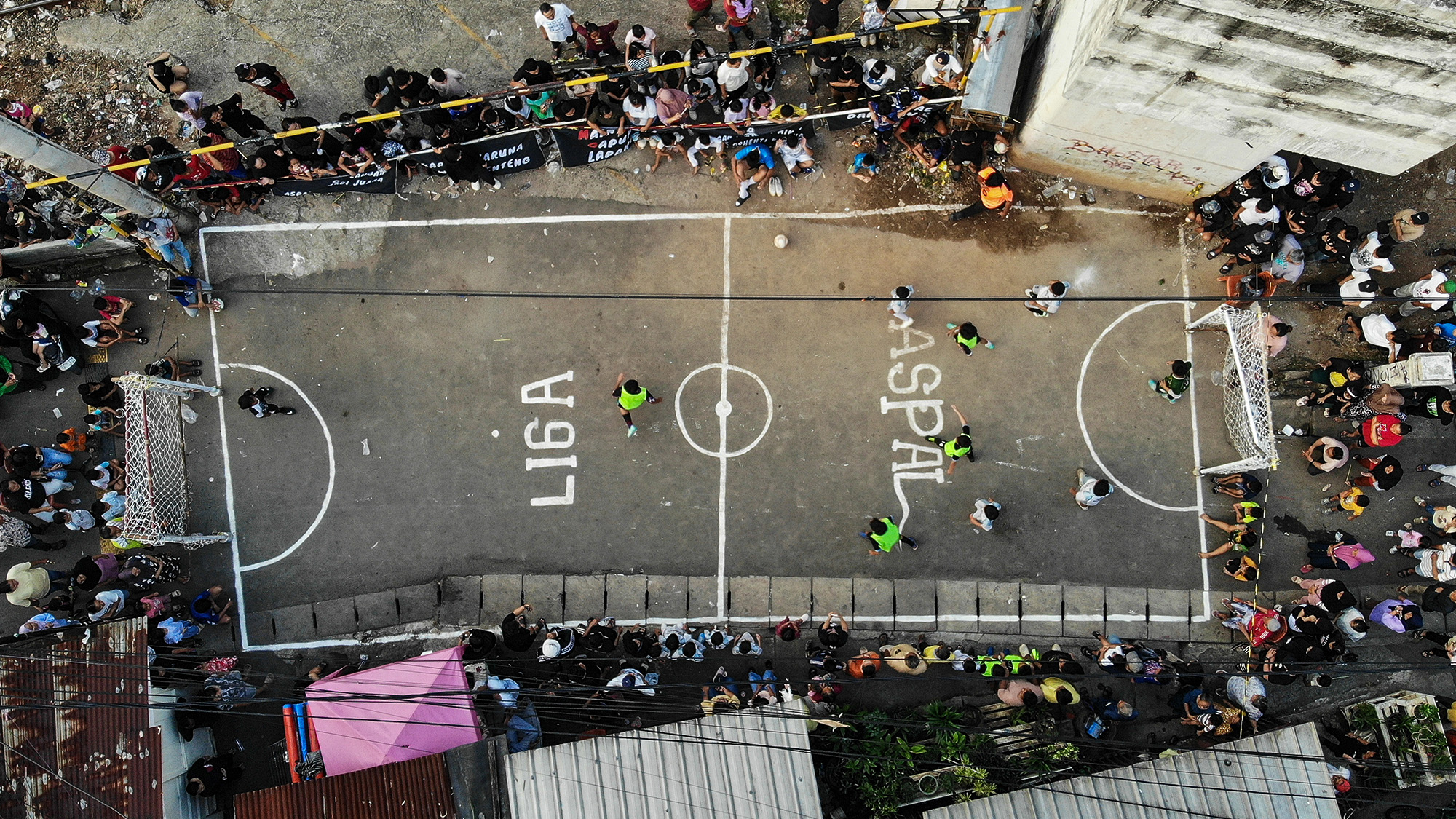 Children compete in a street football tournament locally known as 