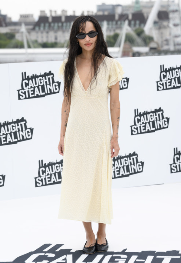 zoe kracitz wearing a dress and balet flats
