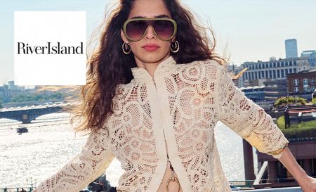 Woman wearing river island's white blouse with shades
