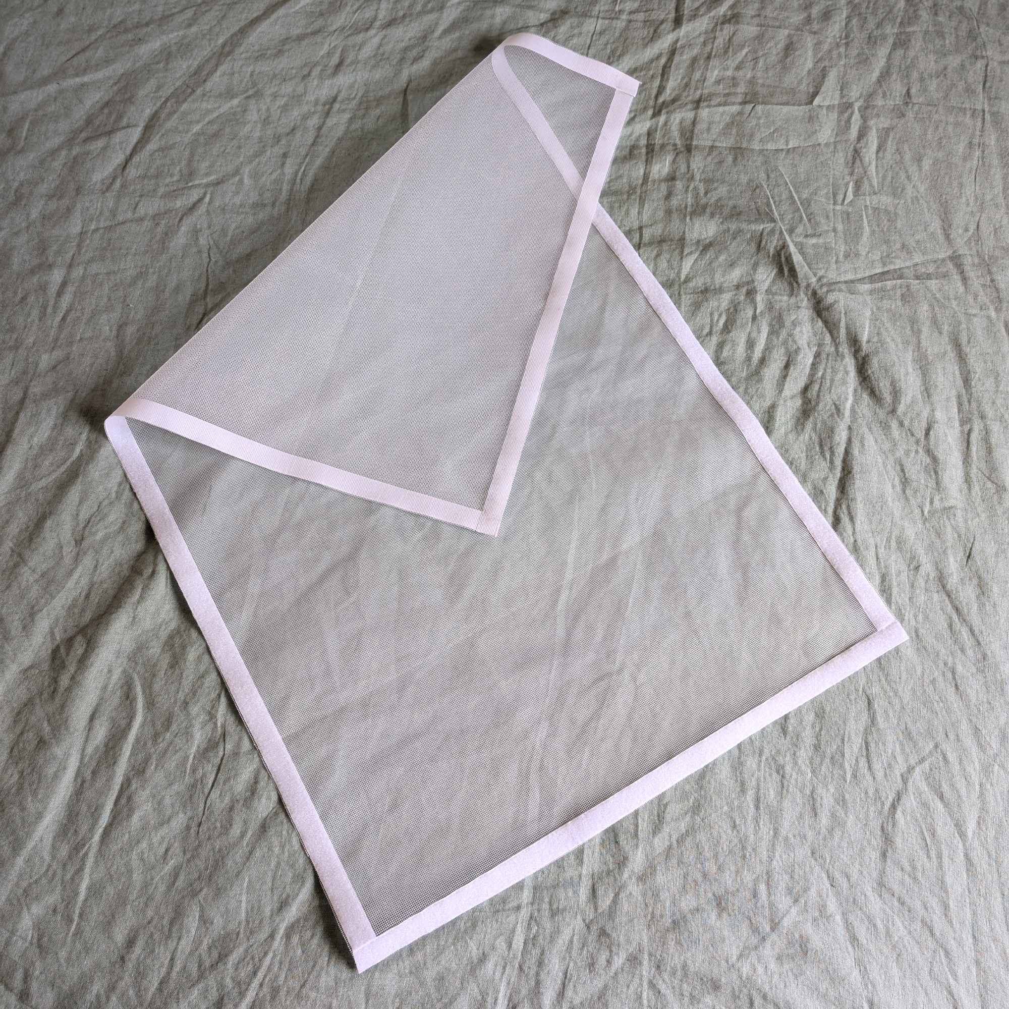 A DIY mosquito screen made with Velcro tape and fly mesh cut to size