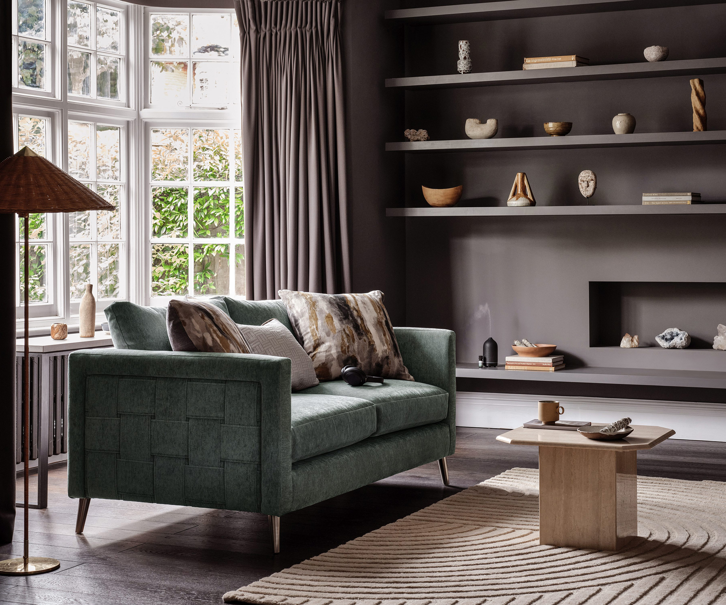 grey living room with open shelving and contemporary fireplace