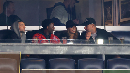 Jerrod Carmichael, Taylor Swift and Travis Kelce attend Game One of the American League Championship Series between the Cleveland Guardians and the New York Yankees at Yankee Stadium on October 14, 2024 in New York City.