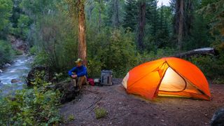 Man camping by river