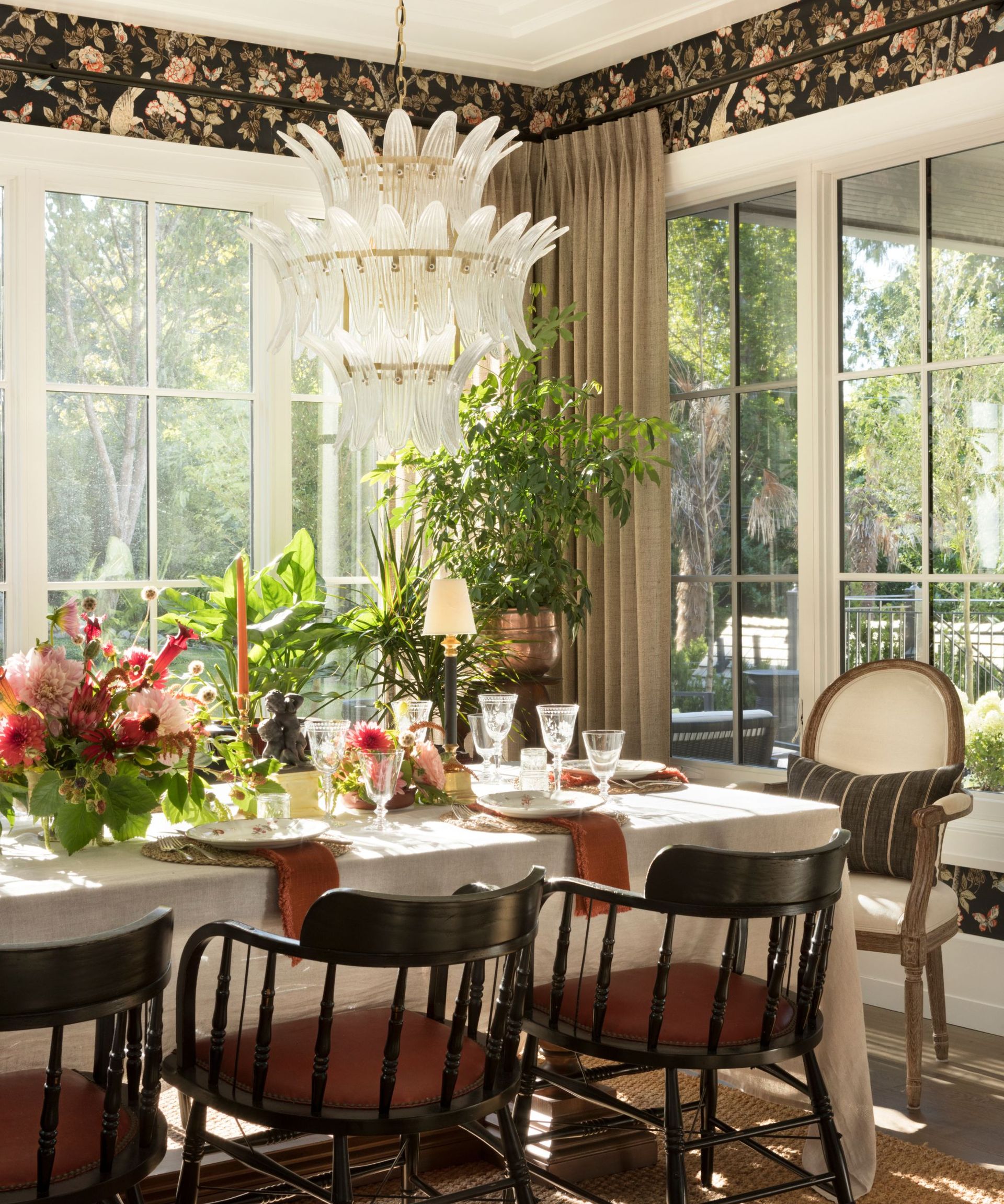 dining room with floral wallpaper and table set with fresh flowers