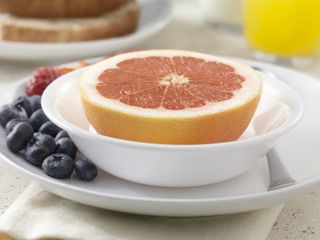 Grapefruit with blueberries, strawberries, wholegrain bread, milk and orange juice - photographed on Hasselblad H3D2-39mb camera