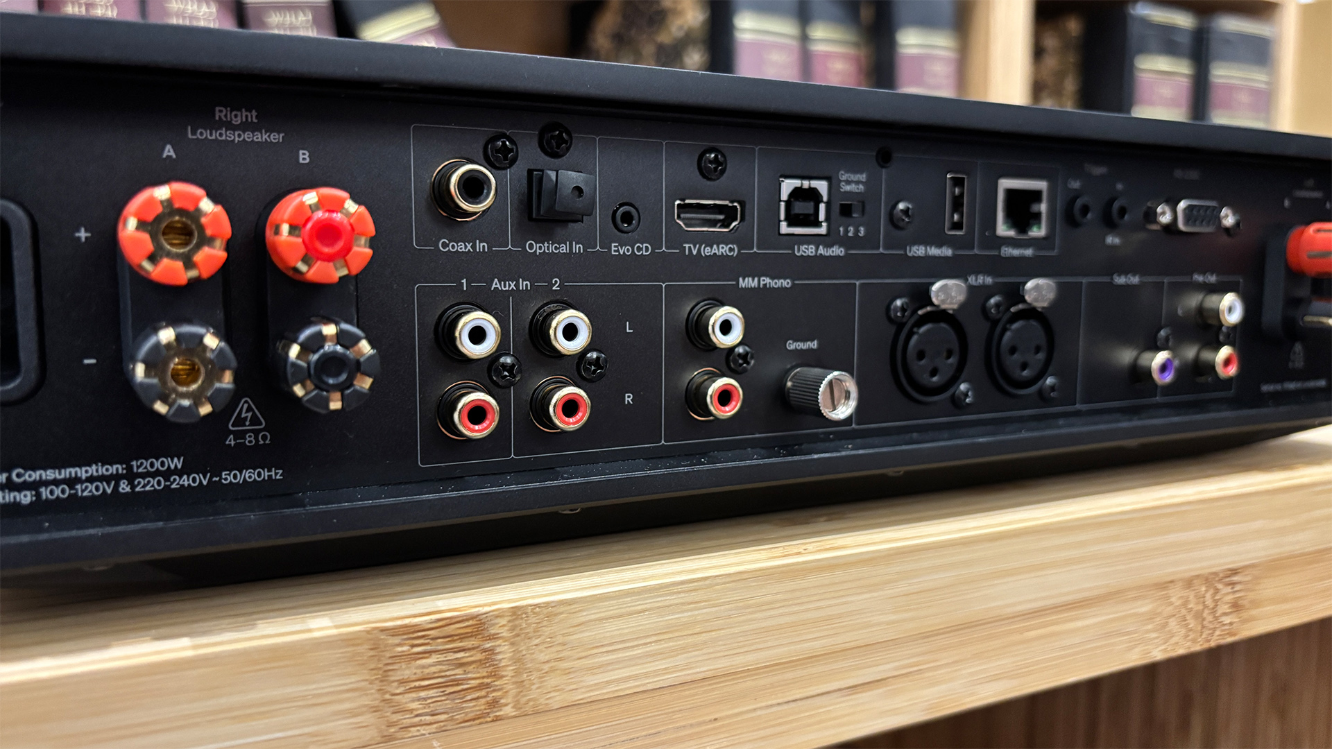 Cambridge Audio Evo 300 all-in-one system on wooden hi-fi rack, rear of unit showing connections