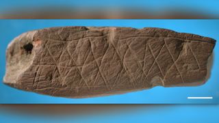 An abstract pattern has been engraved on this piece of ocher found at Blombos Cave in the same archaeological stratum that yielded the silcrete flake.