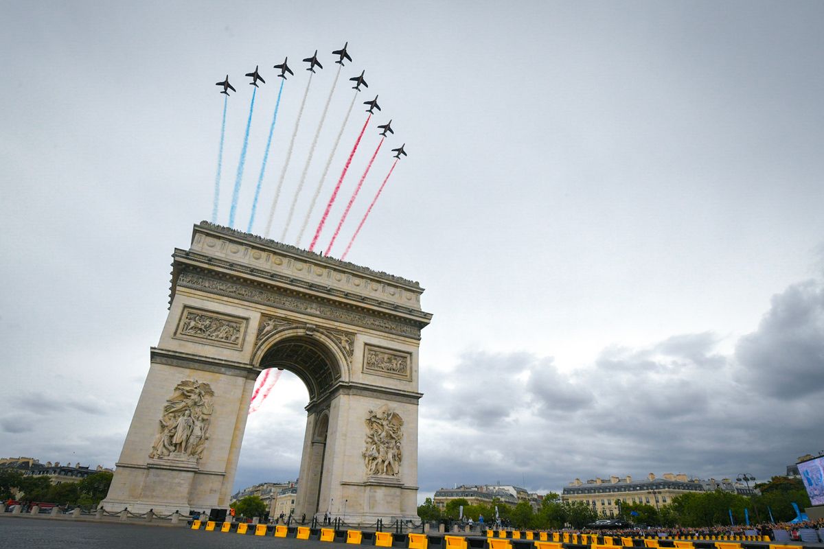 The Patrouille de France fly over the Arc de Triomphe during the final stage