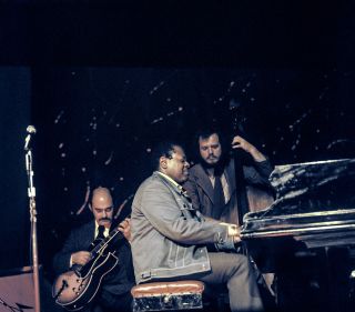 Joe Pass (left) performs onstage with Oscar Peterson and Niels-Henning Ørsted Pedersen in the 1970s