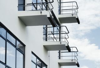 A close-up of four upper level balconies.