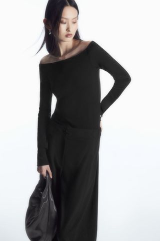 cos sale woman wearing black off the shoulder long sleeved top