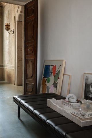 Upholstered bench at Vipp Palazzo with artworks being unpacked