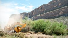 A bulldozer plows through land during construction for a section of border barrier near Santa Elena Canyon in Big Bend National Park, Texas.