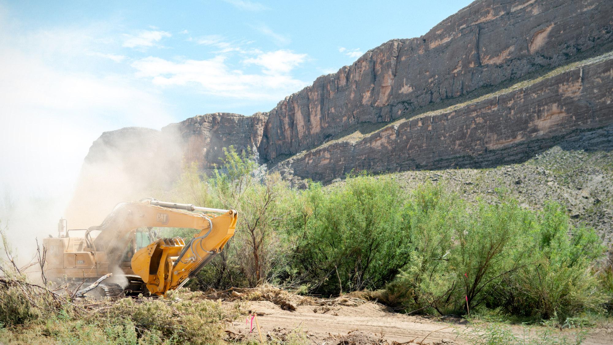 A bulldozer plows through land during construction for a section of border barrier near Santa Elena Canyon in Big Bend National Park, Texas.