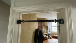 The Gravity Fitness Universal Door Pull-Up bar installed in a doorframe