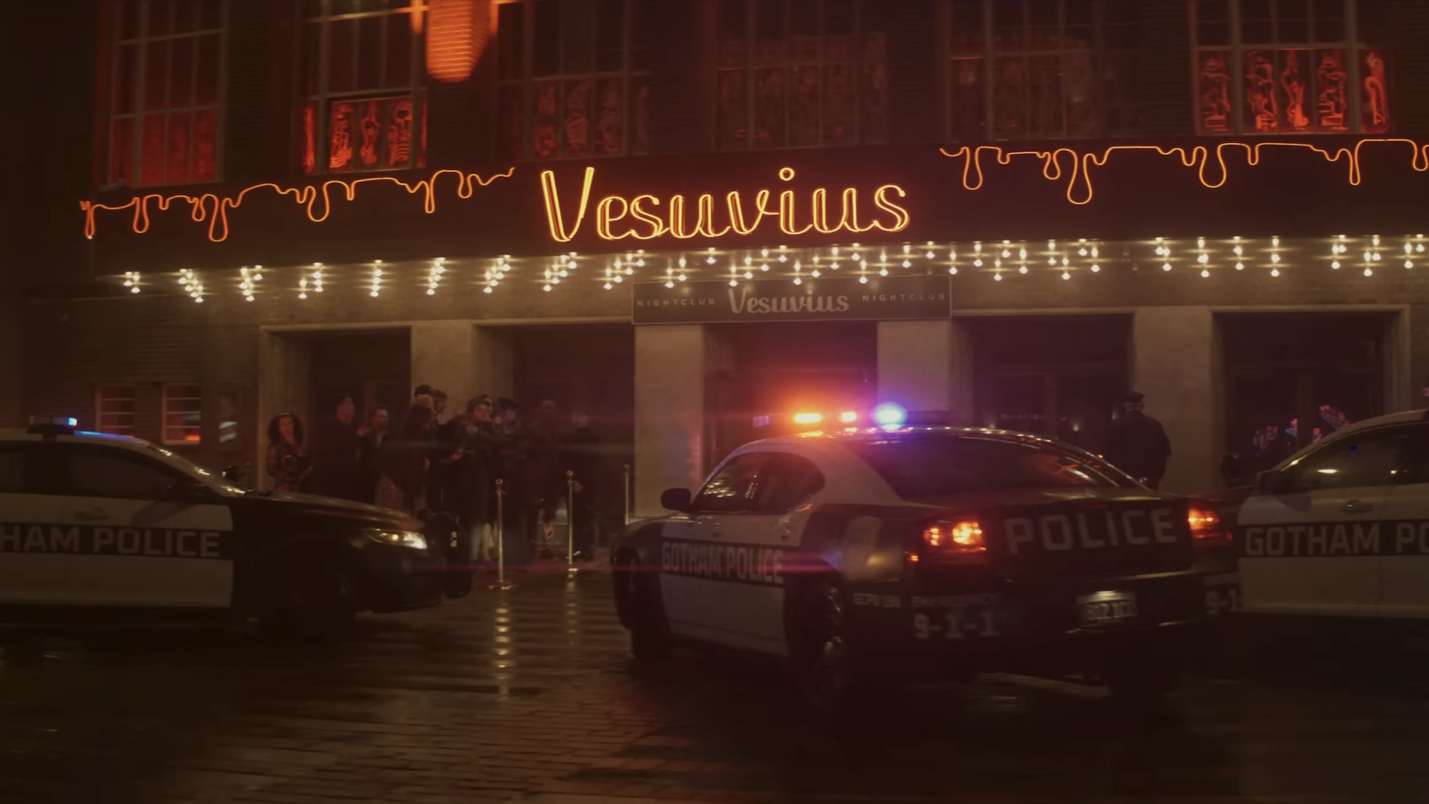 Vesuvius nightclub with cop cars surrounding the front in Clayface
