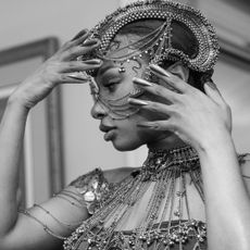 a close up of megan thee stallion getting ready for the gaurav gupta show at paris couture week