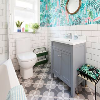 bathroom with flower pattern design titles and pink and green wallpaper