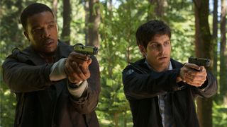 Hank (Russell Hornsby) and Nick (David Giuntoli) (L-R) holding pistols in "Grimm"