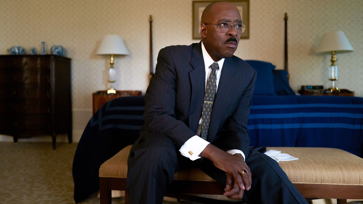 Courtney B. Vance as Jeremy Horne sitting in a hotel room in Heist 88