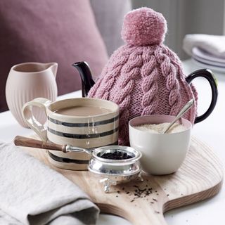 tea cup sugar with tea powder and woolen tea pot