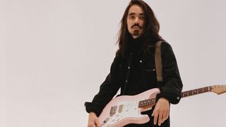 Mateus Asato with his pink Suhr signature guitar