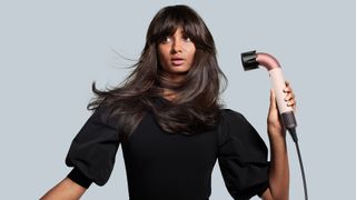 Woman using Dyson Supersonic r hair dryer