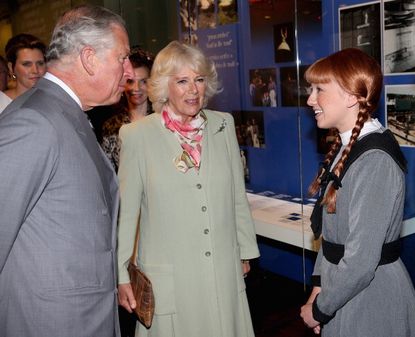 An actress portraying Anne of Green Gables meets with Prince Charles and the Duchess of Cornwall.
