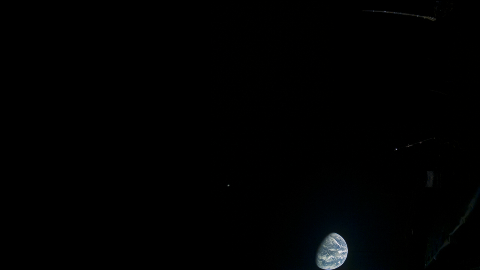 The Earth and moon are seen together in the dark of space by Europe's Jupiter Icy Moons Explorer spacecraft during a Aug. 21, 2024 flyby.