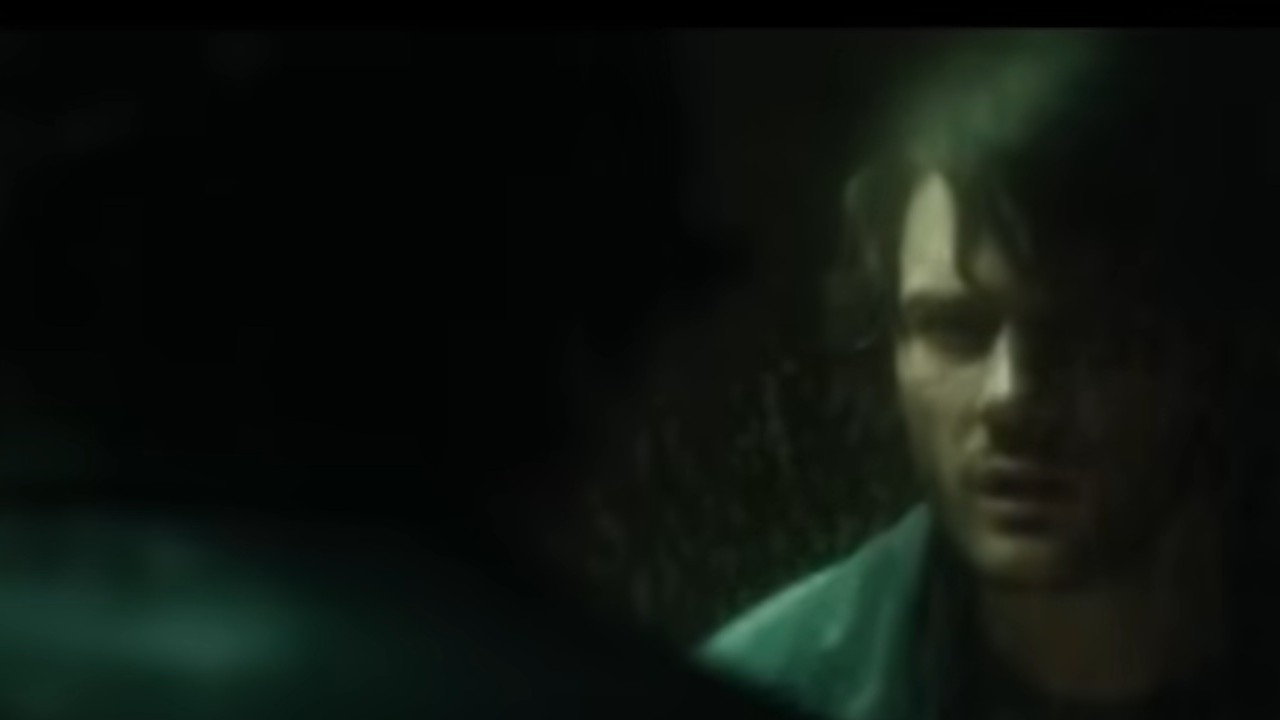 Jeremy Irvine looking at himself in a mirror in Return to Silent Hill