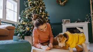 A dog helps to open a gift