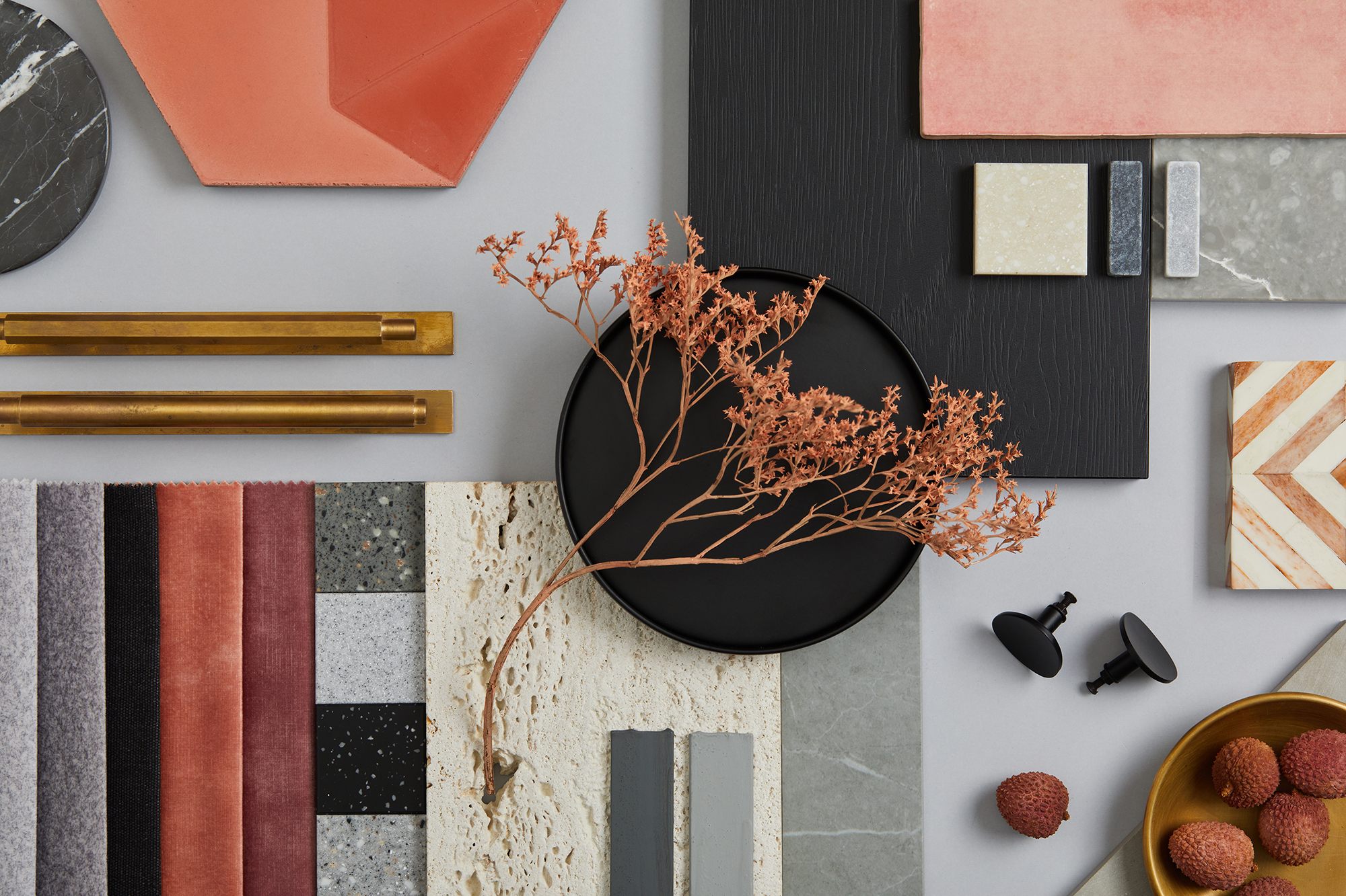 colorful moodboard for a kitchen with tiles fabrics and hardware in grays, blacks, reds and creams