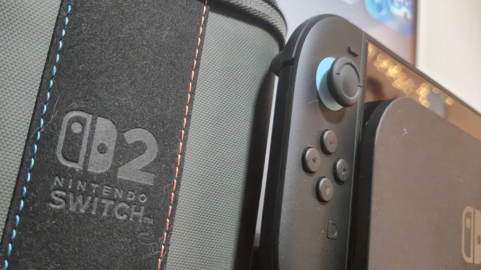 Photo of the Turtle Beach PlayTrek case sitting next to the left side of the Switch 2 and its dock.