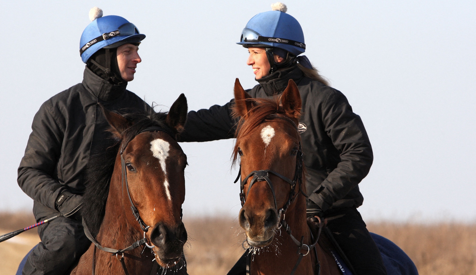 Two riders chatting on horseback