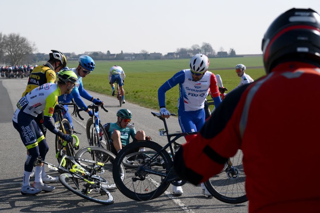 IntermarcheWantyGobert Materiauxs Belgian rider Loc Vliegen L JumboVismas Australian rider Rohan Dennis 2L BORAhansgrohes Dutch rider Danny van Poppel C and GroupamaFDJs French rider Olivier Le Gac R react after a fall during the 2nd stage of the 80th edition of the Paris Nice cycling race 1595 km between Auffargis and Orleans on March 7 2022 Photo by FRANCK FIFE AFP Photo by FRANCK FIFEAFP via Getty Images