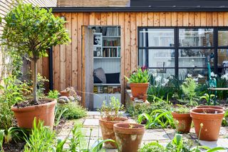 Modern garden ideas: wood-clad sunken garden room with Crittal-style glazing