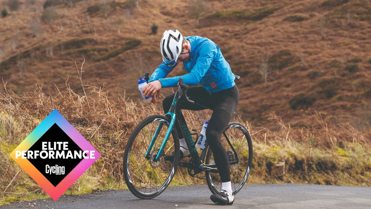 Male cyclist taking a break on the side of a country lane during a bike ride