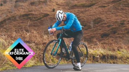 Male cyclist taking a break on the side of a country lane during a bike ride