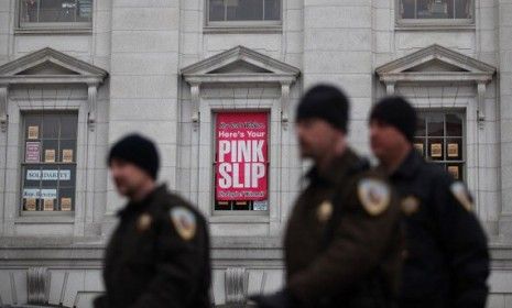 A sign calls for the resignation of Gov. Scott Walker (R-Wis.). 